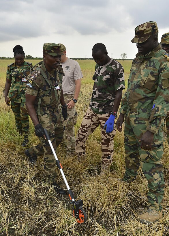 Ghanaian air force Capt. Panyin Sasu-Antwi uses a measuring wheel to calculate ground distance Sept. 14,2016, during African Partnership Flight in Accra, Ghana. The team practiced the procedures of establishing a drop zone. (U.S. Air Force Staff Sgt. Stephanie Longoria)