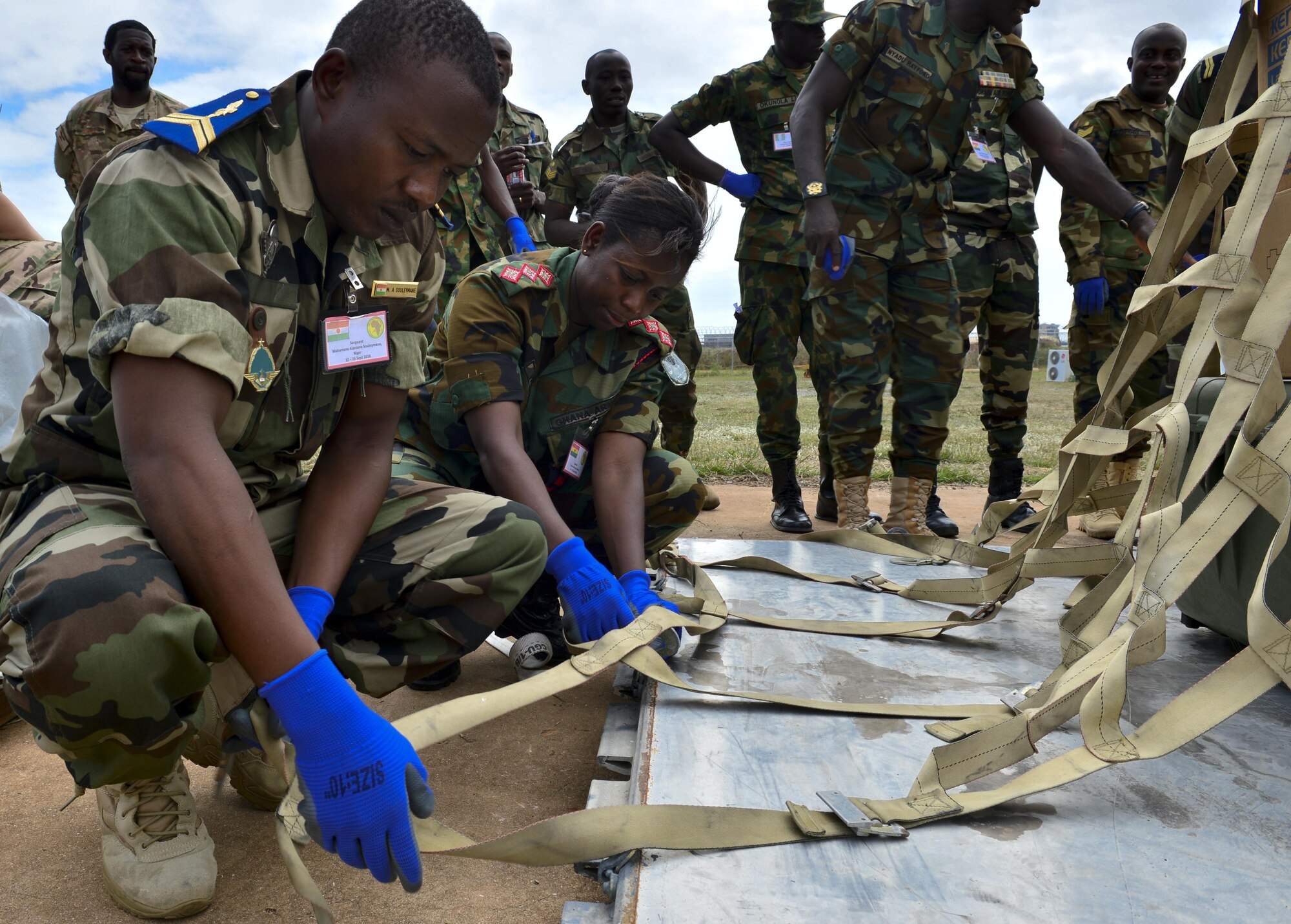 Nigerien Sgt. Mahamane Souleymane and Ghanian Army Capt. Selorm Mensah, secure a pallet during African Partnership Flight in Accra, Ghana, Sept. 14, 2016. AFP Ghana course topics included deployment command and control; airfield standup and operations; airbase logistical support; airbase defense; C-130 tactics, techniques and procedures; and aerial patient movement. (U.S. Air Force Staff Sgt. Stephanie Longoria)