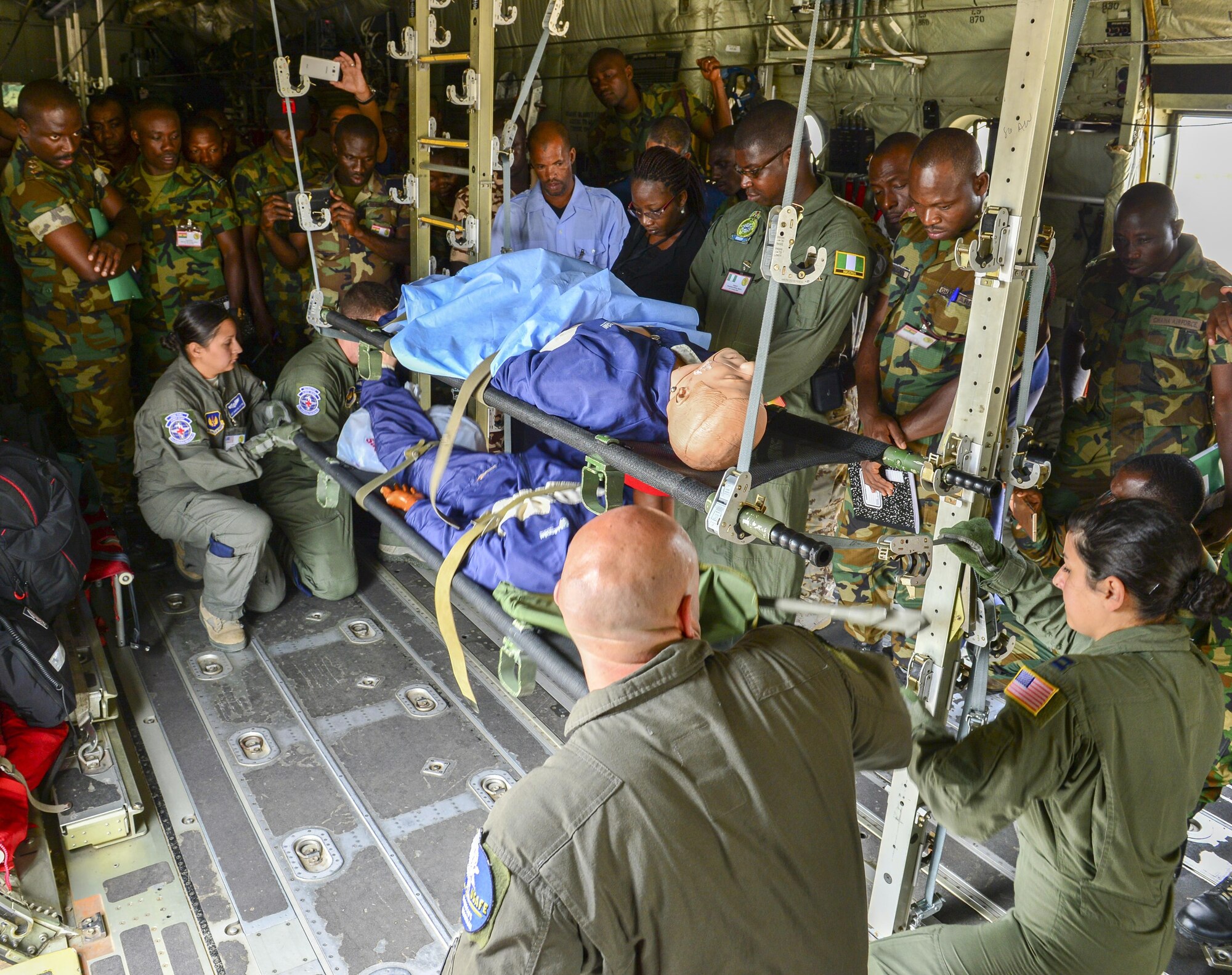 U.S. Air Force Airmen from the 86th Aeromedical Evacuations Squadron, demonstrate how to carry a patient on and off a C-130J Super Hercules Sept. 14,2016, during African Partnership Flight in Accra, Ghana. The team practiced loading and unloading patients onto a C-130 and saw the 86th AES capabilities during an in the air emergency scenario. (U.S. Air Force Staff Sgt. Stephanie Longoria)