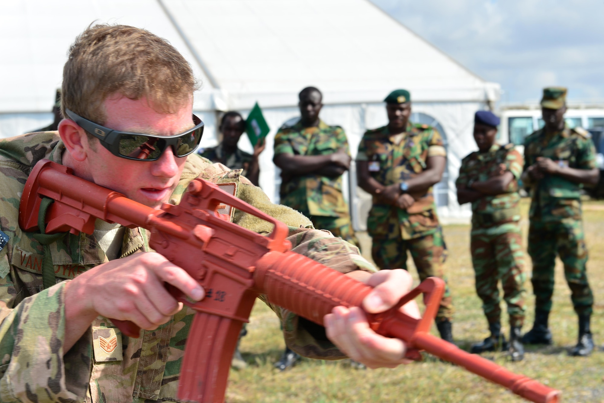 U.S. Air Force Staff Sgt. Jake Van Dyke, 435th Security Forces Squadron contingency response fire team member, demonstrates how to manipulate a weapon when clearing a building to prevent accidents during African Partnership Flight in Accra, Ghana, Sept. 16, 2016. APF was created to enhance overall African sovereignty and interoperability. (U.S. Air Force Staff Sgt. Stephanie Longoria)