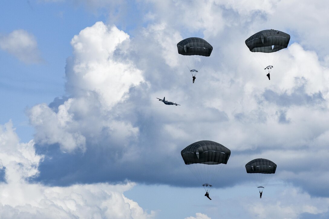 U.S. Air Force Airmen from the 823d Base Defense Squadron drift during a static-line jump, Sept. 16, 2016, at the Lee Fulp drop zone in Tifton, Ga. In the event that two Airmen collide, they’re trained to put their bodies in a “starfish” shape to prevent tangling in each other’s parachute. (U.S. Air Force photo by Daniel Snider) 