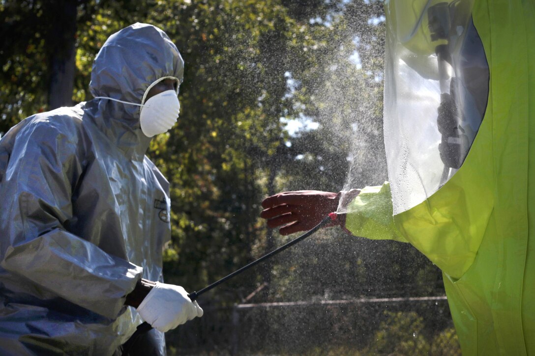 Air National Guard Airman Thojae Peoples, left, performs decontamination procedures on Staff Sgt. Seth Schoenfeld during Exercise Clean House at Joint Base McGuire-Dix-Lakehurst, N.J., Sept. 14, 2016. Peoples and Schoenfeld are emergency management airmen assigned to the New Jersey National Guard’s 108th Civil Engineering Squadron. Air National Guard photo by Tech. Sgt. Matt Hecht