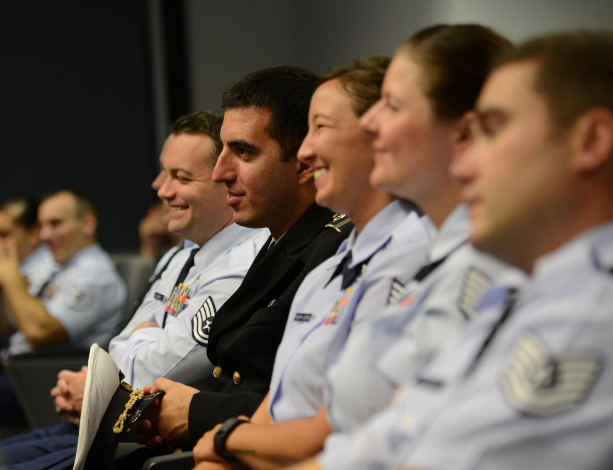 Kisling NCO Academy students laugh after retired Air Force Lt. Col. Melvin Pollack, Vietnam War veteran and former prisoner of war, makes a joke while sharing his experience of spending five years and eight months in a North Vietnamese prison camp, September 12, 2016, Kapaun Air Station, Germany. Pollack encouraged students not to take their survival training for granted, telling them it will be useful in adverse times. (U.S. Air Force photo/ Airman 1st Class Joshua Magbanua)