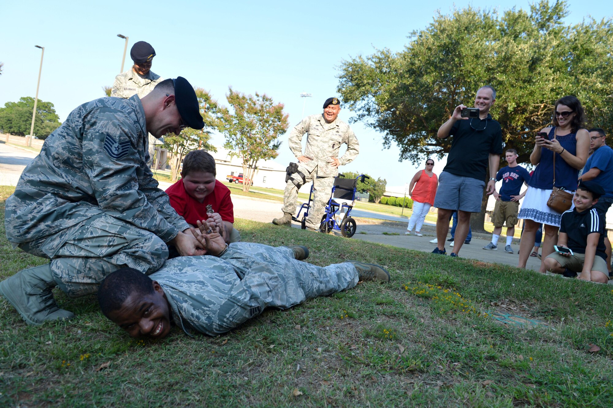 Jake Pritchard, 20th Security Forces Squadron honorary defender, apprehends a simulated “suspect” during a “Defender for a Day” event at Shaw Air Force Base, S.C., Sept. 9, 2016. Pritchard, who has Duchenne muscular dystrophy, received the opportunity to serve alongside 20th SFS Airmen, as well as learn how to properly apprehend a suspect. (U.S. Air Force photo by Airman 1st Class Christopher Maldonado)