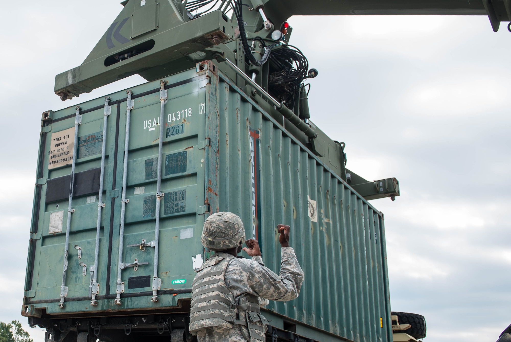 A U.S. Army Soldier, assigned to the 56th Transportation Battalion 567th Inland Cargo Transportation Company, guides a Kalmar forklift into position during training at Joint Base Langley-Eustis, Va., Sept. 8, 2016. The training gave Soldiers, new to the unit, hands-on training with the Kalmar forklift and 10K forklift. (U.S. Air Force photo by Airman 1st Class Derek Seifert)