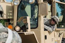 U.S. Army Spc. Vincent Seen, 56th Transportation Battalion 567th Inland Cargo Transportation Company cargo specialist, waits for directions while unloading cargo at Joint Base Langley-Eustis, Va., Sept. 8, 2016. The company simulated being stationed at a port in Italy, where they received shipments via sea and air. (U.S. Air Force photo by Airman 1st Class Derek Seifert)