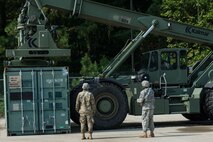 U.S. Army Soldiers, assigned to the 56th Transportation Battalion 567th Inland Cargo Transportation Company, guide a Kalmar forklift into position during training at Joint Base Langley-Eustis, Va., Sept. 8, 2016. Cargo specialists ensure Army forces receive supplies, weapons, equipment and mail all over the world. (U.S. Air Force photo by Airman 1st Class Derek Seifert)
