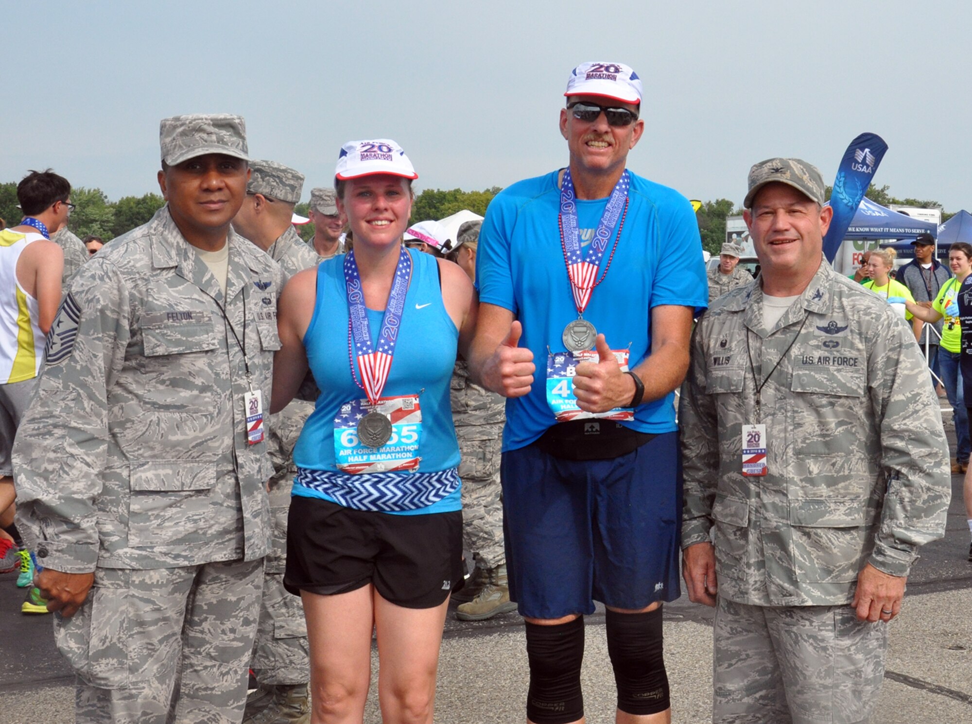 First lt. Brianne Koessel and her father, Chief Master Sgt. Brian Fowle, both from the 445th Aeromedical Evacuation Squadron, pose with Chief Master Sgt. James Felton, 445th Airlift Wing command chief, and Col. Adam Willis, 445th Airlift Wing commander, after completing the Air Force Marathon half marathon. (U.S. Air Force photo/Lt. Col. Cynthia Harris)