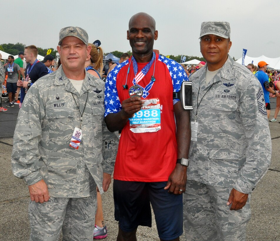 First lt. Brianne Koessel and her father, Chief Master Sgt. Brian Fowle, both from the 445th Aeromedical Evacuation Squadron, pose with Chief Master Sgt. James Felton, 445th Airlift Wing command chief, and Col. Adam Willis, 445th Airlift Wing commander, after completing the Air Force Marathon half marathon. (U.S. Air Force photo/Lt. Col. Cynthia Harris)