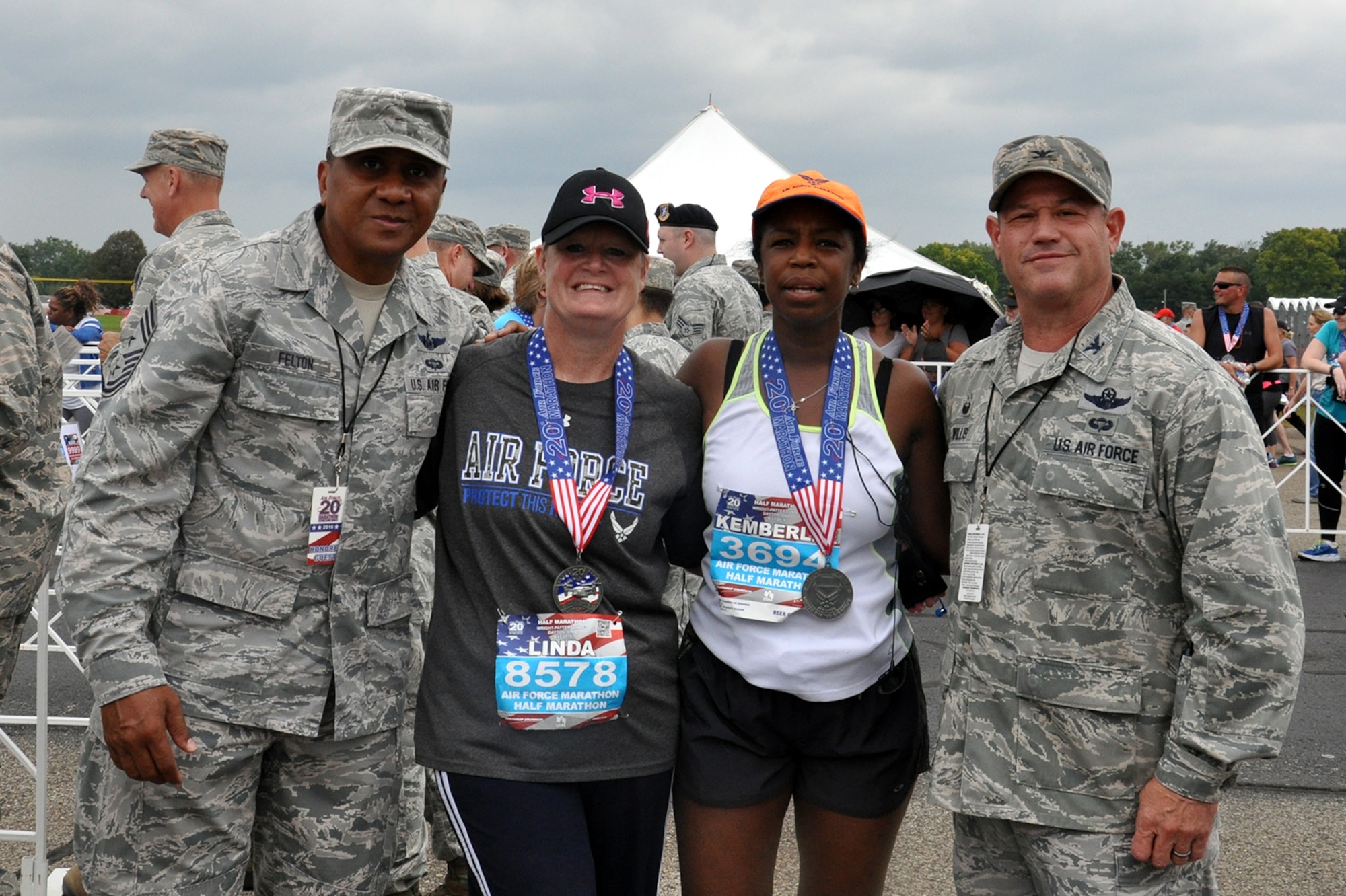 Senior Master Sgt. Linda Sparks, 87th Aerial Port Squadron NCO in-charge, ramp services flight, and Senior Master Sgt. Kemberlee Borders, 445th Civil Engineer Squadron training manager, pose with Chief Master Sgt. James Felton, 445th Airlift Wing command chief, and Col. Adam Willis, 445th Airlift Wing commander, after completing the Air Force Marathon half marathon. (U.S. Air Force photo/Lt. Col. Cynthia Harris)