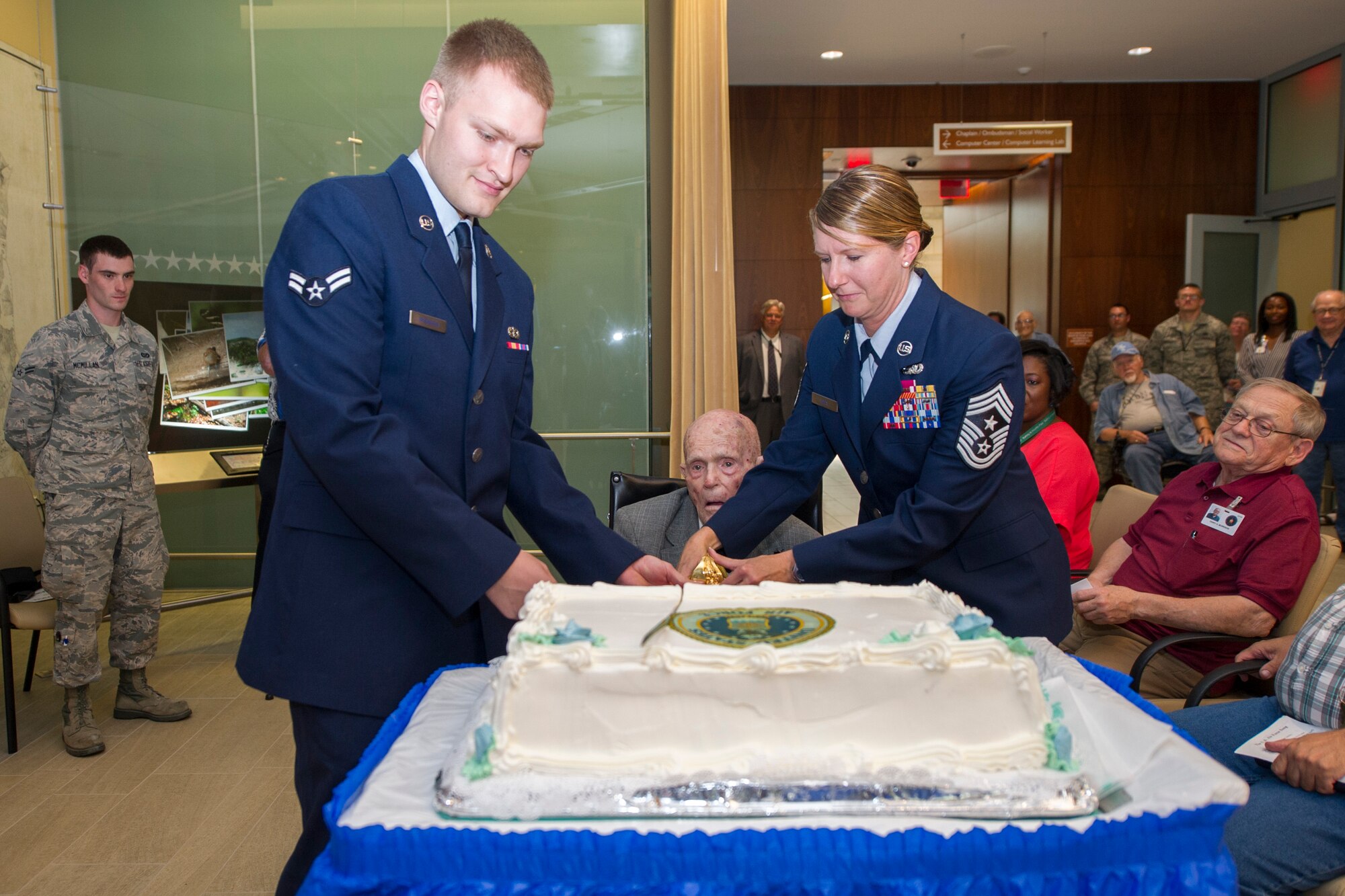Airman 1st Class Logan Wisnoski, left, 11th Civil Engineer Squadron, U.S. Air Force (ret.) Master Sgt. Fay Steele, center, Armed Forces Retirement Home retiree, and Chief Master Sgt. Beth Topa, 11th Wing command chief, cut the cake during the 69th Air Force Birthday Celebration at the AFRH in Washington, D.C., Sep. 16, 2016. Steele and Wisnoski had the privilege of cutting the cake as the oldest and youngest Airmen.