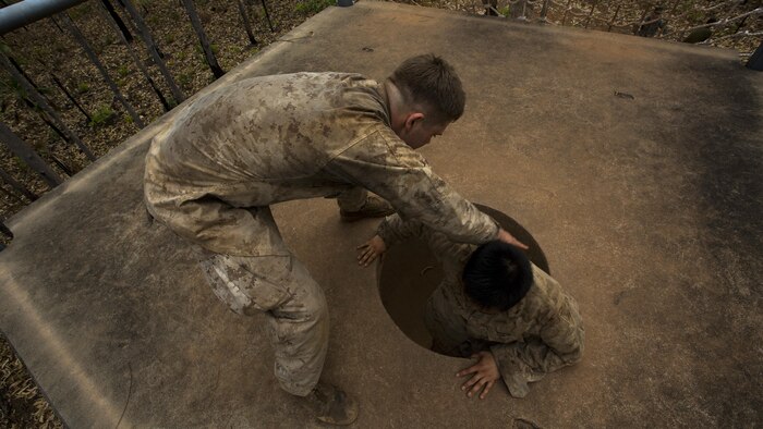 U.S. Marines with 1st Battalion, 1st Marine Regiment, help one another complete an obstacle during the Frontline Leaders Course at Robertson Barracks, Northern Territory, Australia, Sept. 9, 2016. The course is intended to be an addition to the Marine Corps Lance Corporal’s Seminar, Corporal's Course, and Sergeant's Course. The course instills knowledge and leadership skills to positively impact those under their charge and the future of the Marine Corps. 1st Battalion, 1st Marine Regiment, created the course and this will be the first time the course has been officially conducted.