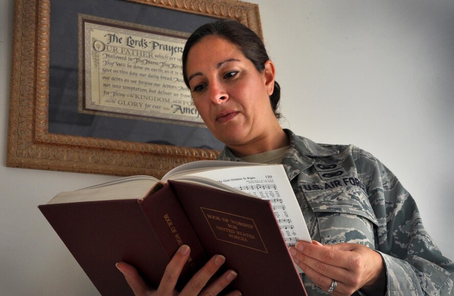 Staff Sgt. Jamie Link, 94th Airlift Wing Chapel Corps chaplain’s assistant, reviews hymns from the Book of Worship for United States Forces at Dobbins Air Reserve Base, Georgia on August 7, 2016. Hymns are used during the Sunday unit training assembly services to get attendees involved. (U.S. Air Force photo by Senior Airman Lauren Douglas)