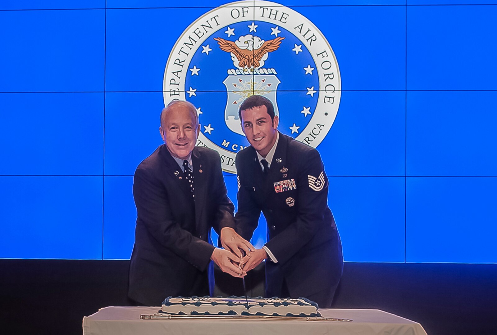 Defense Supply Center Columbus personnel celebrated the Air Force's 69th birthday Sept. 14. Retired Air Force Col. Jim McClaugherty, acting DLA Land and Maritime commander (left) and Tech Sgt. Elijah Loughridge cut the birthday cake as the oldest and youngest Airmen in attendance.