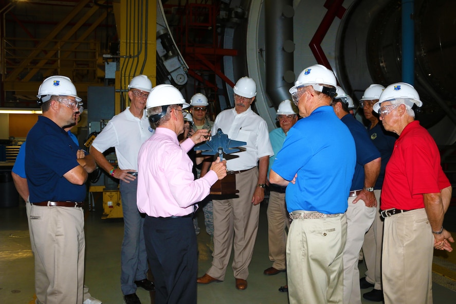 Mike Dent, Aeropropulsion Combined Test Force Deputy Director, holds up an F-35 model while speaking to a tour group consisting of mayors, aldermen and representatives from Coffee County and cities of Manchester and Tullahoma in the Aeropropulsion Systems Test Facility C-1 test cell Aug. 10. The purpose of the visit was to foster community relationships and discuss recent contract transitions, the Service Life Extension Program and Hypersonic investments and proposed Air Force Test Center alignment.  (U.S. Air Force photo/Holly Peterson)