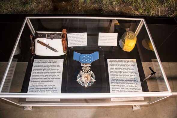 DAYTON, Ohio -- Leather belt, holster for a .38 caliber pistol, and a survival knife.  Sergeant (later MSgt) Fred Cook, a door gunner with the 20th Special Operations Squadron, wore these items on Lt Fleming’s November 26, 1968, Medal of Honor mission. Mechanic’s cap with the 20th SOS Green Hornet printed on the visor and front.  It belonged to Fred Cook but was not worn on the Medal of Honor mission.  These items are on display in the Southeast Asia War Gallery at the National Museum of the United States Air Force. (U.S. Air Force photo by Ken LaRock)