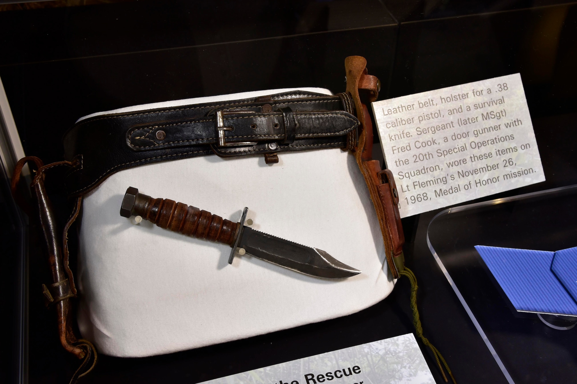 DAYTON, Ohio -- Leather belt, holster for a .38 caliber pistol, and a survival knife on display in the Southeast Asia War Gallery.  Sergeant (later MSgt) Fred Cook, a door gunner with the 20th Special Operations Squadron, wore these items on Lt Fleming’s November 26, 1968, Medal of Honor mission. (U.S. Air Force photo by Ken LaRock)