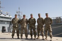 Command Sgt. Maj. William F. Thetford, Command senior enlisted leader of the U.S. Army Central Command, poses for a group photo with Soldiers of the 338th Transportation Detachment during a visit at Kuwait Naval Base, Kuwait, Sept. 14, 2016. Thetford visited the Soldiers to get direct insight into their concerns, accomplishments, and current sustainment operations.