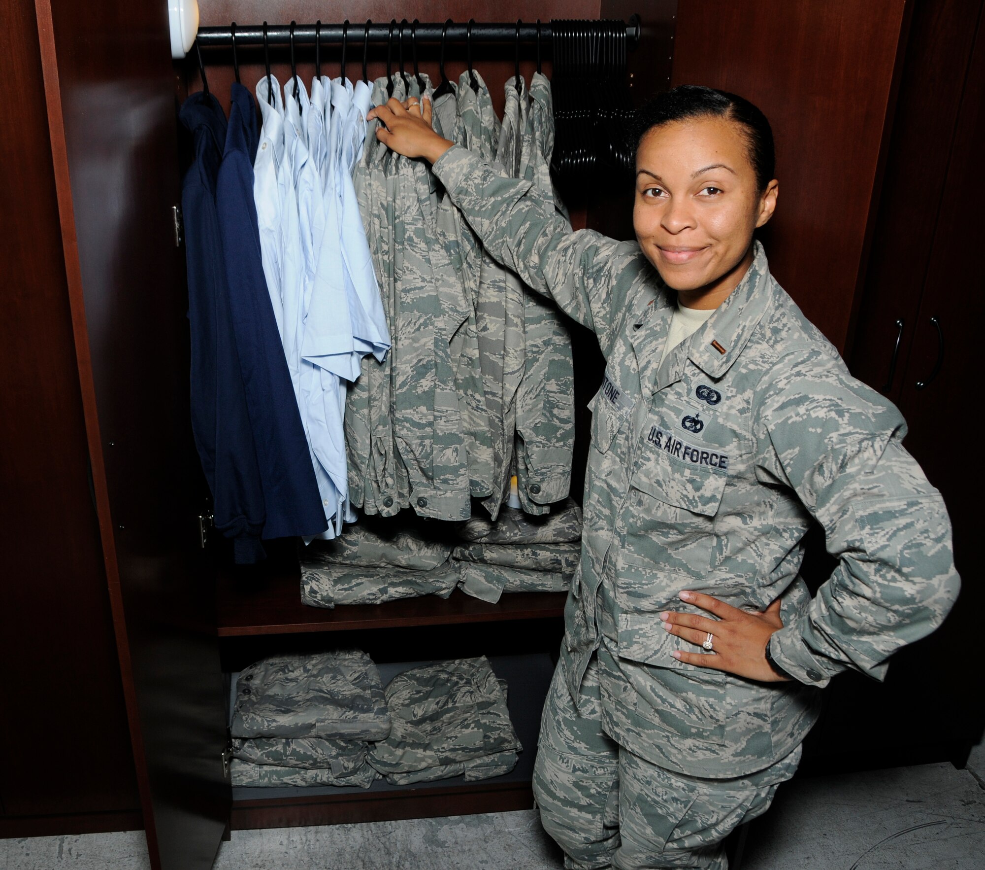 2nd Lt. Shannon Antone, the 482nd Fighter Wing Yellow Ribbon representative showcases what uniform items are available in the new Airman's Closet at Homestead Air Reserve Base, Fla., Sept. 8, 2016. The Airman’s Attic is a collection of uniforms that have been donated by Airmen to assist others who are transitioning to the reserve from prior service. (U.S. Air Force photo by Senior Airman Aja Heiden)