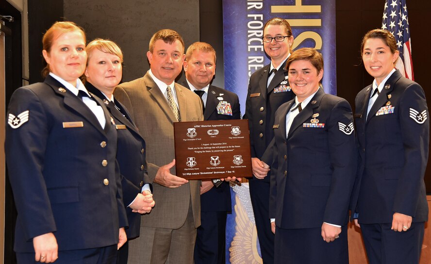 Dr. James Malachowski, Director of Historical Services, Headquarters Air Force Reserve Command, graduates the first class of the AFRC Historian Apprentice Course at Robins Air Force Base, Georgia, Sept. 16, 2016.  The students graduating are Staff Sgt. Brittany Kunz, Staff Sgt. Justyne Strohmeyer, Staff Sgt. Christina Norris, Technical Sgt. Christopher O'Neill and Tech Sgt. Alexis Holcomb.
