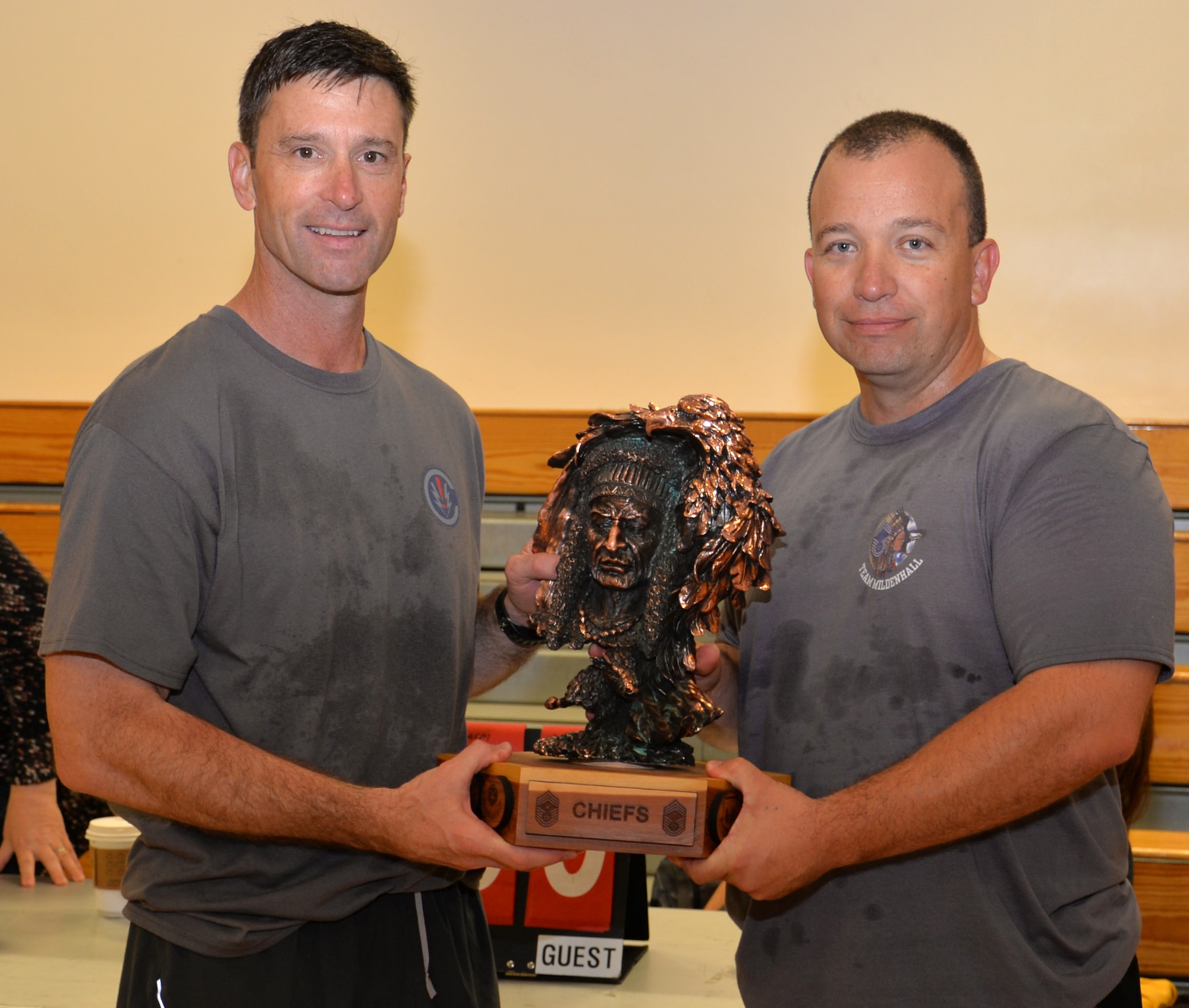U.S. Air Force Col. Matthew Smith, 352nd Special Operations Wing commander, left, hands the "Chiefs vs. Eagles" trophy over to U.S. Air Force Chief Master Sgt. Joseph Krussick, 100th Maintenance Squadron superintendent, and Chief's group president, right, following a “Chiefs vs. Eagles” volleyball game Sept. 16, 2016, on RAF Mildenhall, England. Chief master sergeants emerged victorious on this occasion. (U.S. Air Force photo by Gina Randall)