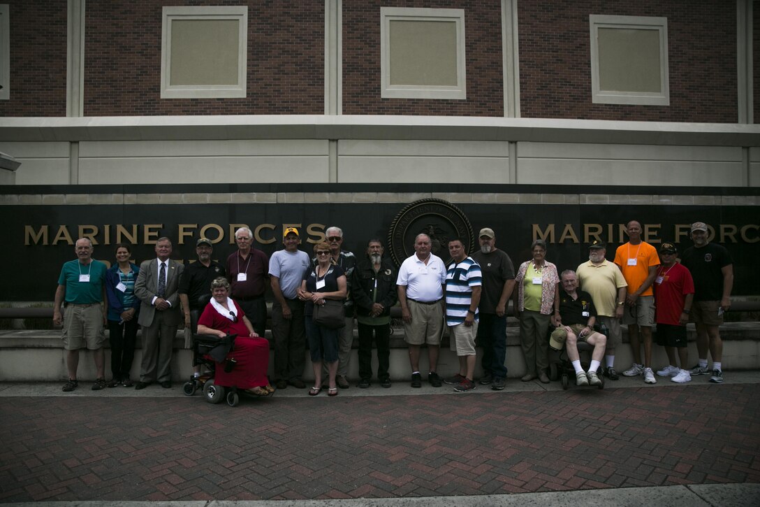 Marine Corps veterans from 3rd Battalion, 11th Marine Regiment, 1st Marine Division, pose for a photo at Marine Corps Support Facility New Orleans along with their spouses, Sept. 16, 2016. The site visit was part of a week-long annual "Battery Adjust XI Reunion," celebrating the 25th anniversary of 3/11 Marines who served in Operation Desert Storm, and the 50th anniversary of 3/11 Marines landing in Vietnam. 