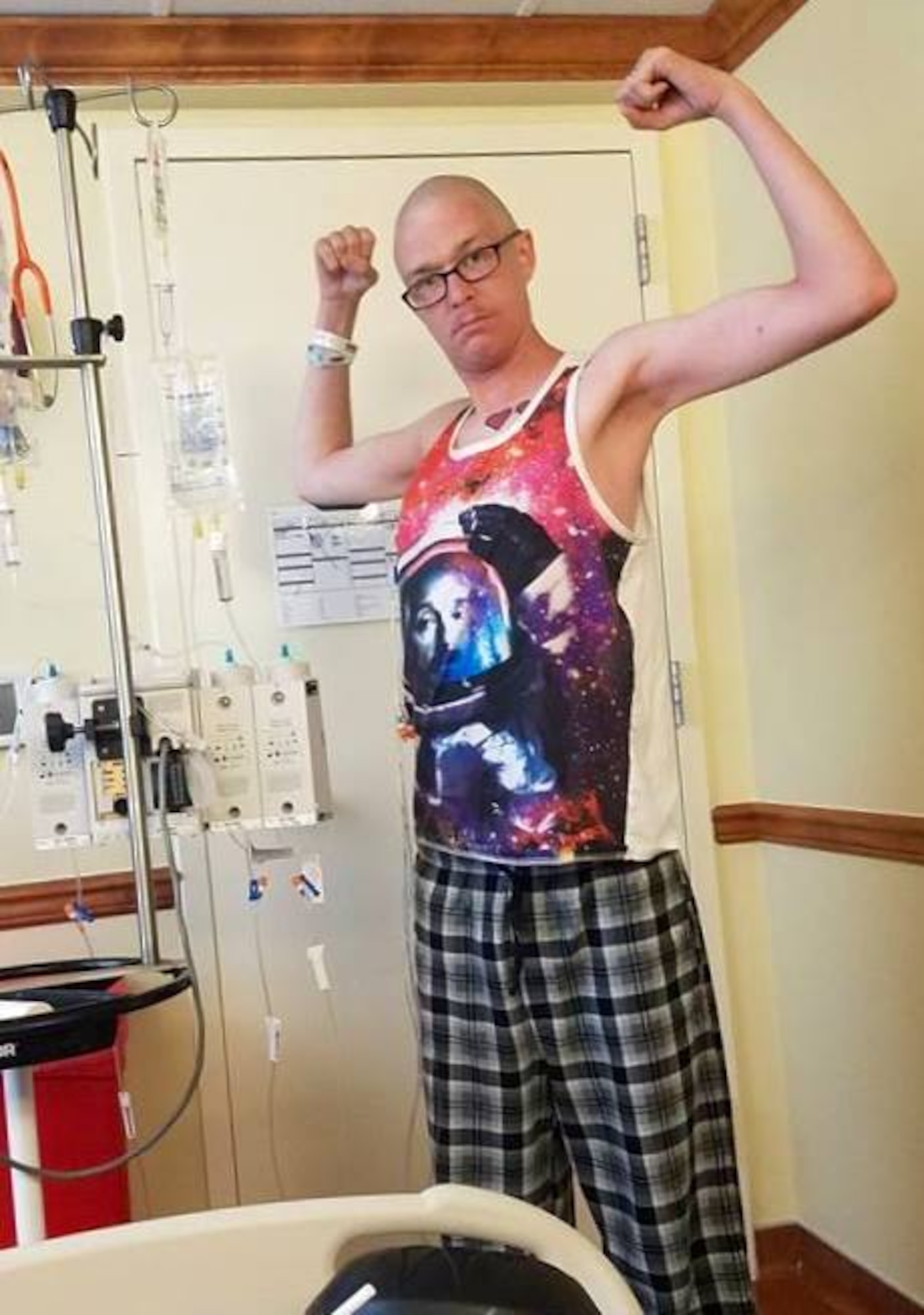 DENVER, Colo. -- Staff Sgt. Ryan Meston, 4th SPCS space system operator, strikes a triumphant pose while receiving chemotherapy at Colorado Blood Cancer Institute in Denver. Meston battled testicular cancer and leukemia back-to-back and is now in remission for both. (Courtesy photo)