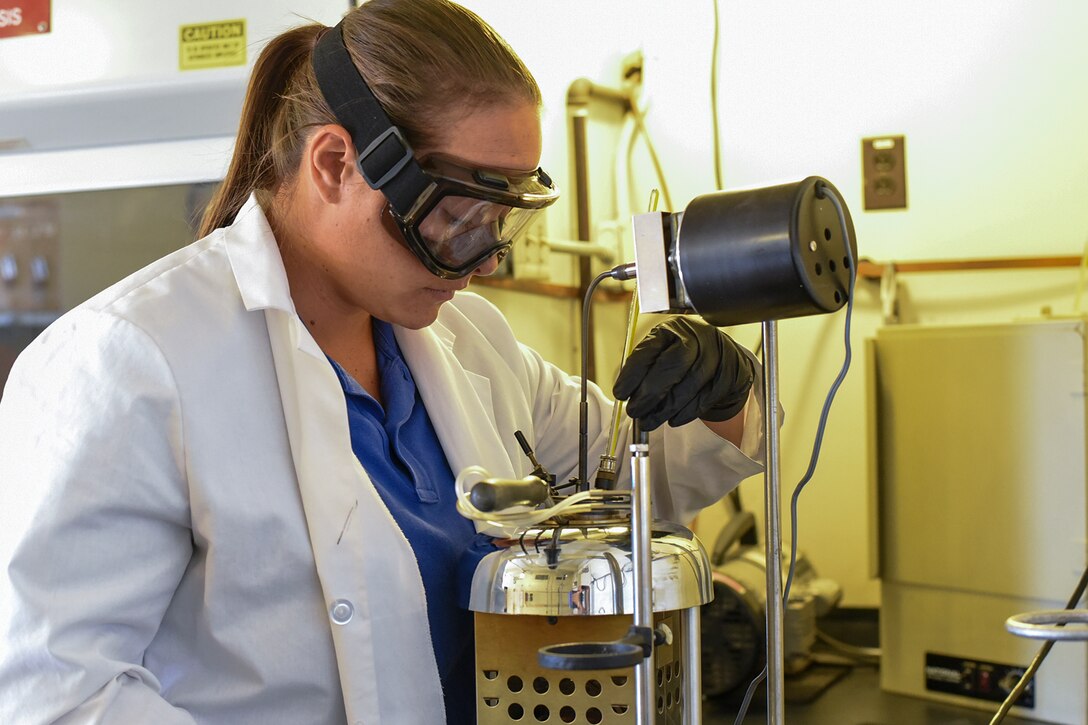 PETERSON AIR FORCE BASE, Colo. – Nicole Lira, a fuels distribution system operator with Defense Logistics Agency, performs a flash test on a fuel sample taken from one of their trucks after refueling at Peterson Air Force Base, Colo., Sept. 19, 2016. Even with a primarily space-based mission, the operations tempo on Peterson’s flightline is high and keeps the fuels shop busy.  (U.S. Air Force photo by Philip Carter)