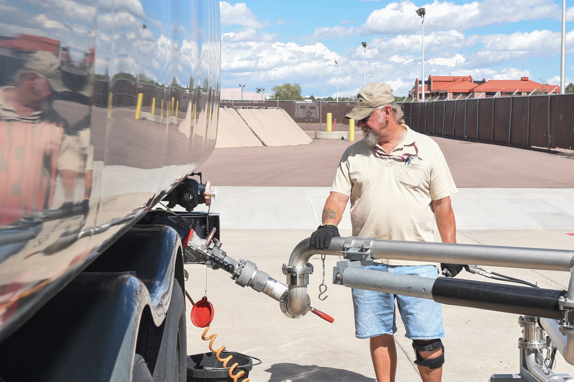 PETERSON AIR FORCE BASE, Colo. – Donald Mitchell, a fuels distribution system operator with Defense Logistics Agency, refills a fuel truck at Peterson Air Force Base, Colo., Sept. 19, 2016. The dual-safety features include an automatic shut-off when the fuel reaches the top of the tank, and also a kill-switch that shuts off the pump if anything were to happen to the operator and they release their grip on the switch. (U.S. Air Force photo by Philip Carter)