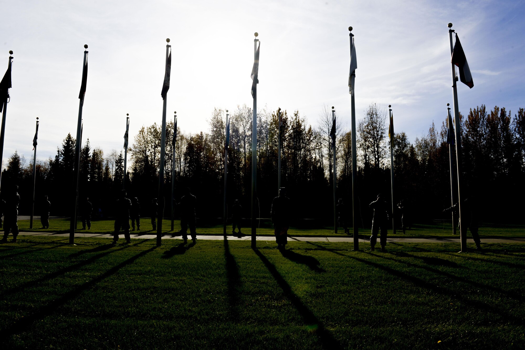 U.S. Air Force Airmen assigned to the 354th Fighter Wing prepare to lower state flags during the POW/MIA Recognition Day Retreat Ceremony, Sept. 16, 2016, at Heritage Park on Eielson Air Force Base, Alaska. The ceremony is held every year to honor the POW’s and those MIA. (U.S. Air Force photo by Airman Isaac Johnson)