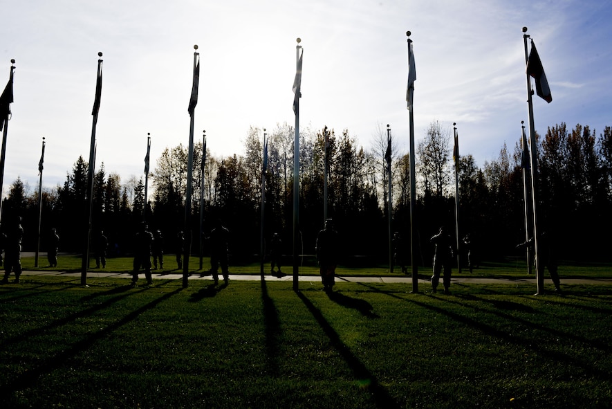 U.S. Air Force Airmen assigned to the 354th Fighter Wing prepare to lower state flags during the POW/MIA Recognition Day Retreat Ceremony, Sept. 16, 2016, at Heritage Park on Eielson Air Force Base, Alaska. The ceremony is held every year to honor the POW’s and those MIA. (U.S. Air Force photo by Airman Isaac Johnson)