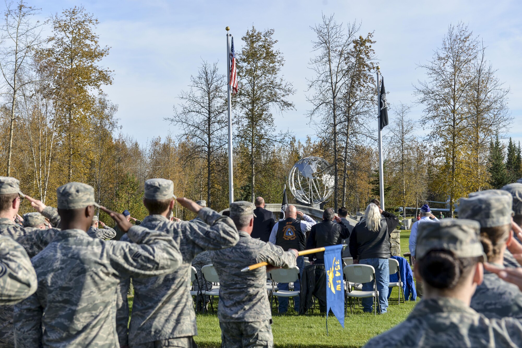 U.S. Air Force Airmen and civilians assigned to the 354th Fighter Wing salute the POW/MIA flag during the POW/MIA Recognition Day Retreat Ceremony, Sept. 16, 2016, at Heritage Park on Eielson Air Force Base, Alaska. POW/MIA Recognition day is typically recognized on the third Friday of September every year. (U.S. Air Force photo by Airman Isaac Johnson)