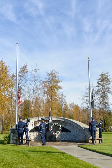 Members of the 354th Fighter Wing and Ben Eielson Junior/Senior High School Air Force Junior ROTC Honor Guardsmen lower the American and POW/MIA flags during the POW/MIA Recognition Day Retreat Ceremony, Sept. 16, 2016, at Heritage Park on Eielson Air Force Base, Alaska. The first POW/MIA Recognition Day was in 1979. (U.S. Air Force Photo by Airman Isaac Johnson)