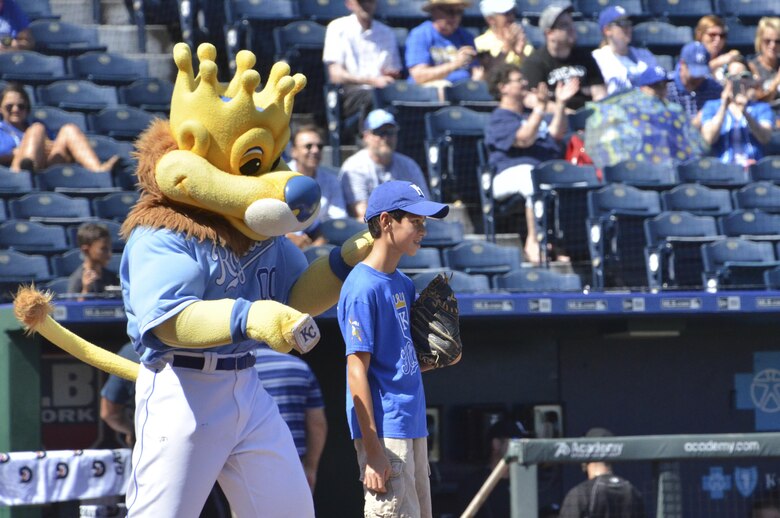 Sluggerrr, the Kansas City Royals mascot, preps Alex Marks before his father, a 303rd Fighter Squadron pilot, throws him the opening pitch for the Royals game at Kauffman Stadium in Kansas City, Mo., Sept. 19, 2016. (U.S. Air Force photo/Senior Airman Missy Sterling)