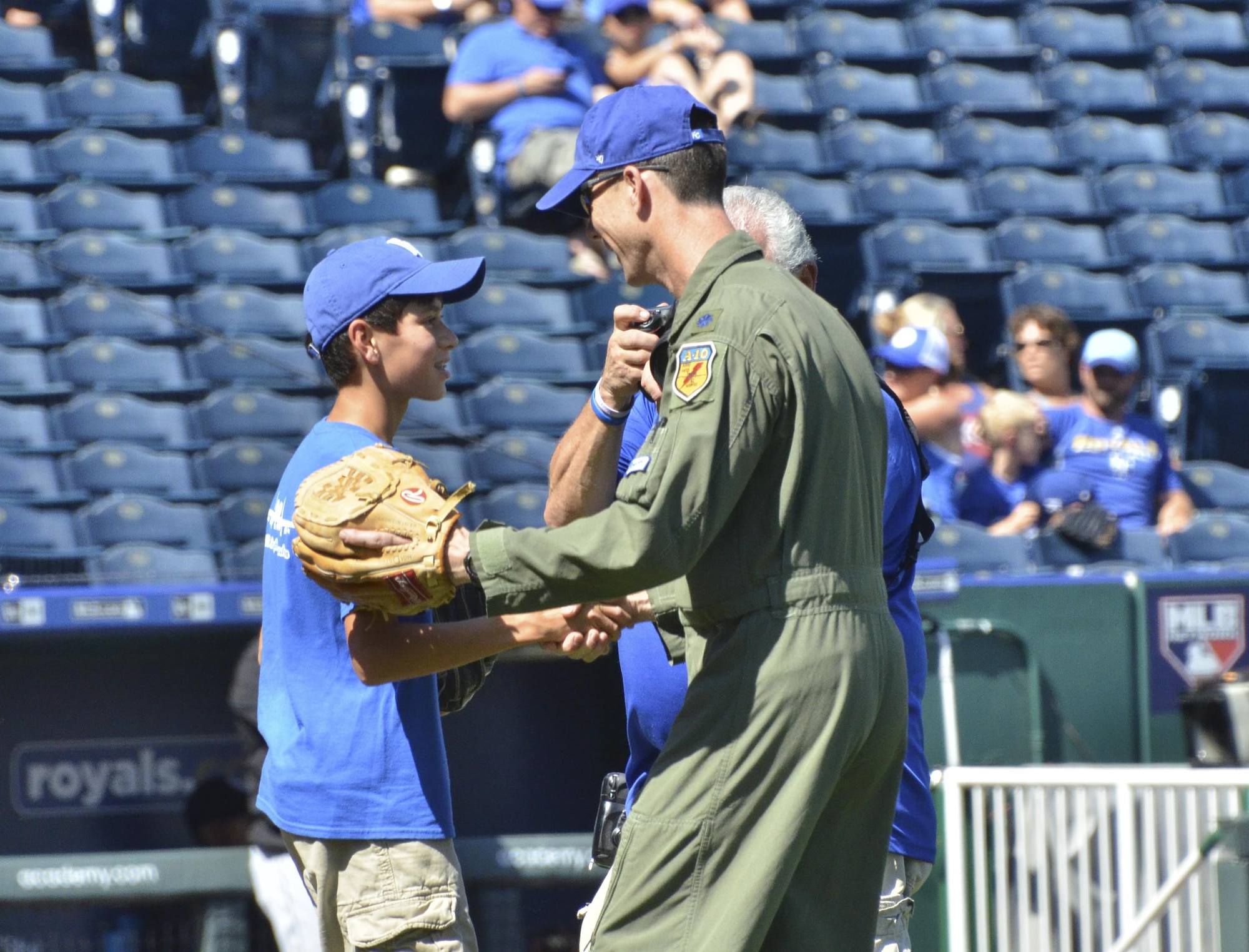 U.S. Air Force Lt. Col. John Marks, 303rd Fighter Squadron pilot, shakes hands with his son Alex after he threw the opening pitch for the Kansas City Royals game against the Chicago White Sox at Kauffman Stadium in Kansas City, Mo., Sept. 19, 2016. The Royals finished the game with an 8-3 win over the White Sox. (U.S. Air Force photo/Senior Airman Missy Sterling)