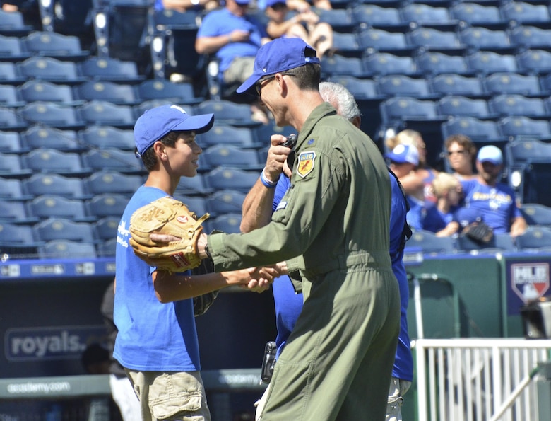 U.S. Air Force Lt. Col. John Marks, 303rd Fighter Squadron pilot, shakes hands with his son Alex after he threw the opening pitch for the Kansas City Royals game against the Chicago White Sox at Kauffman Stadium in Kansas City, Mo., Sept. 19, 2016. The Royals finished the game with an 8-3 win over the White Sox. (U.S. Air Force photo/Senior Airman Missy Sterling)