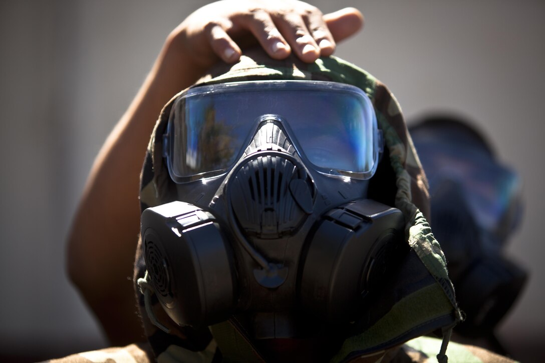 U.S. Marine Corps Cpl. Suhr J. Wilsonmanson, maintenance management specialist assigned to Combat Assault Company, 3rd Marine Regiment, participates in Mission Oriented Protective Posture gear exchange during the Chemical, Biological, Radiological, and Nuclear (CBRN) Reconnessaince and Surveillance Training Course aboard Marine Corps Training Area Bellows, Hawaii, Aug. 10, 2016. Select Marines within the Regiment under-went the training designed to equip them with the capability to confirm or deny CBRN presence on the battlefield. 