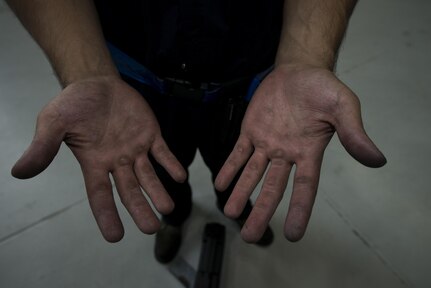 Staff Sgt. Richard Brazen, 437th Maintenance Squadron Sheet Metal and Corrosion Shop aircraft structure technician, shows his hands after working on a damaged C-17 Globemaster III at Joint Base Charleston, South Carolina, Sept. 14, 2016. The Sheet Metal and Corrosion shop is responsible for repair of the aircraft structure, composites and corrosion control of the C-17. 