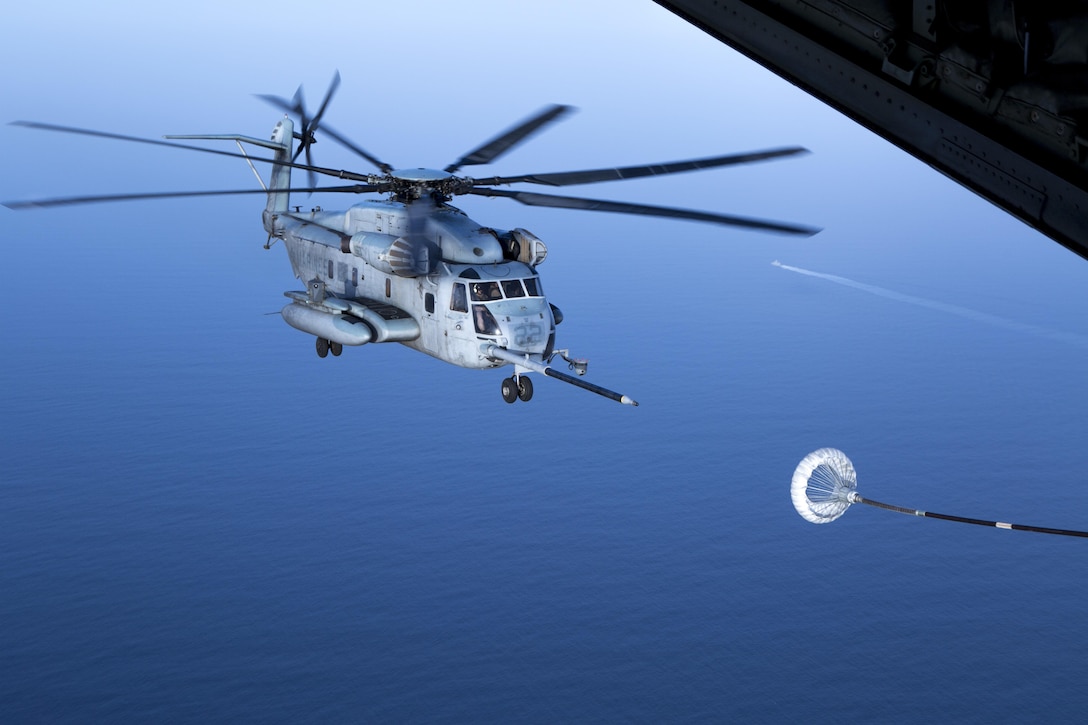 A CH-53E Super Stallion with the 22nd Marine Expeditionary Unit approaches the refueling hose of a Marine Aerial Refueler Squadron - 352 C-130 Hercules for air-to-air refueling over the Red Sea, July 30, 2016. VMGR – 352 is currently a component of Special Purpose Marine Air-Ground Task Force-Crisis Response-Central Command, forward deployed to the U.S. Central Command area of responsibility supporting a variety of missions. VMGR-352 supported aerial refuel training for multiple 22nd MEU CH-53s demonstrating synergy between the two MAGTFs.