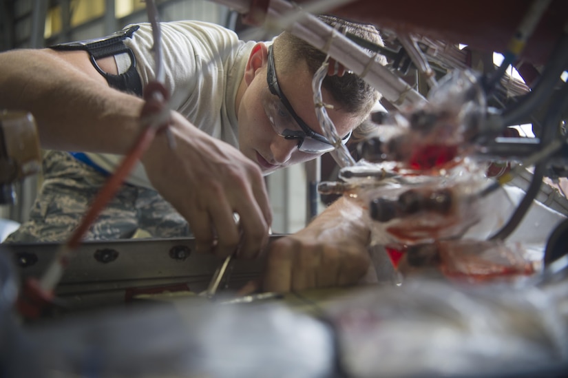 Senior Airman John Yesis, 437th Maintenance Squadron Sheet Metal and Corrosion Shop aircraft structural technician, repairs an engine torque box on a C-17 Globemaster III at Joint Base Charleston, South Carolina, Sept. 14, 2016. The torque box helps control the thrust reverser control valve module allowing the thrusters in the engine to work properly. 