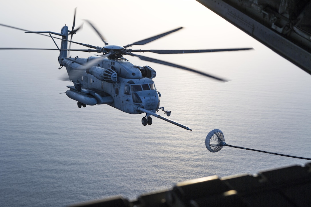 A CH-53E Super Stallion with the 22nd Marine Expeditionary Unit approaches the refueling hose of a Marine Aerial Refueler Squadron - 352 C-130 Hercules for air-to-air refueling over the Red Sea, July 30, 2016. VMGR – 352 is currently a component of Special Purpose Marine Air-Ground Task Force-Crisis Response-Central Command, forward deployed to the U.S. Central Command area of responsibility supporting a variety of missions. VMGR-352 supported aerial refuel training for multiple 22nd MEU CH-53s demonstrating synergy between the two MAGTFs.