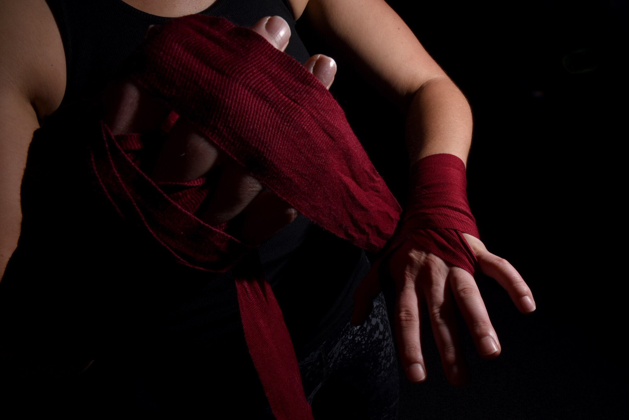 COLORADO SPRINGS, Colo. – Senior Airman Rose Gudex, 21st Space Wing Public Affairs photojournalist, wraps her hands before a kickboxing session at a local gym in Colorado Springs Sept. 14, 2016. After going through difficult situations throughout her life, Gudex turned to kickboxing and fitness as a way to channel frustrations. (U.S. Air Force photo by Airman 1st Class Dennis Hoffman)