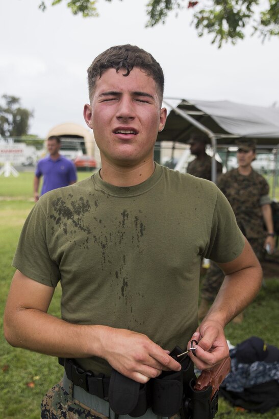 MARINE CORPS BASE HAWAII – Lance Cpl. Peter Rando, an airframe mechanic with Marine Aviation Logistics Squadron 24, and a Galloway, N.J., native, waits in line to wash his face after finishing a defensive and offensive tactics course near the Provost Marshal’s Office aboard Marine Corps Base Hawaii, Aug. 18, 2016. Marines from various units are undergoing a two-week training course to support the PMO as part of the Gate Augmentation Force.  One of the training requirements necessary for completing the program, service members must conduct defensive and offensive tactics in response to a simulated attack after having been pepper sprayed.  Instructors exposed the service members to the spray in order to reinforce the importance of remaining calm, should they be contaminated by it in the future.  (U.S. Marine Corps photo by Lance Cpl. Jesus Sepulveda Torres)