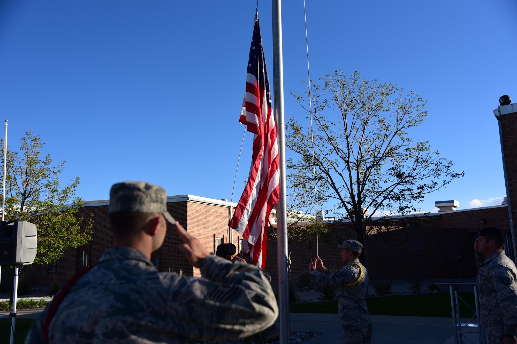 PETERSON AIR FORCE BASE, Colo. - Members of the Vosler NCO Academy raise the American flag during a ceremony to commemorate POW/MIA Remembrance Week at Peterson Air Force Base, Colo., Sept. 13, 2016. The POW/MIA flag was flown for 24-hours, taken down and carried in a 24-hour run and then returned to VNCOA where it was flown for the rest of the week. (U.S. Air Force photo by Staff Sgt. Amber Grimm)