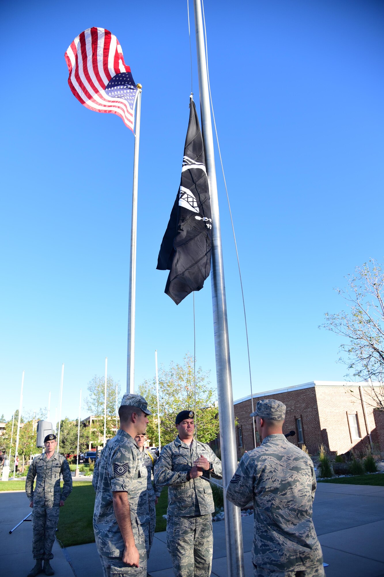 PETERSON AIR FORCE BASE, Colo. - Members of the Vosler NCO Academy perform a flag raising ceremony to commemorate POW/MIA Remembrance Week at Peterson Air Force Base, Colo., Sept. 13, 2016. The POW/MIA flag was flown for 24-hours, taken down and carried in a 24-hour run and then returned to VNCOA where it was flown for the rest of the week. (U.S. Air Force photo by Staff Sgt. Amber Grimm)