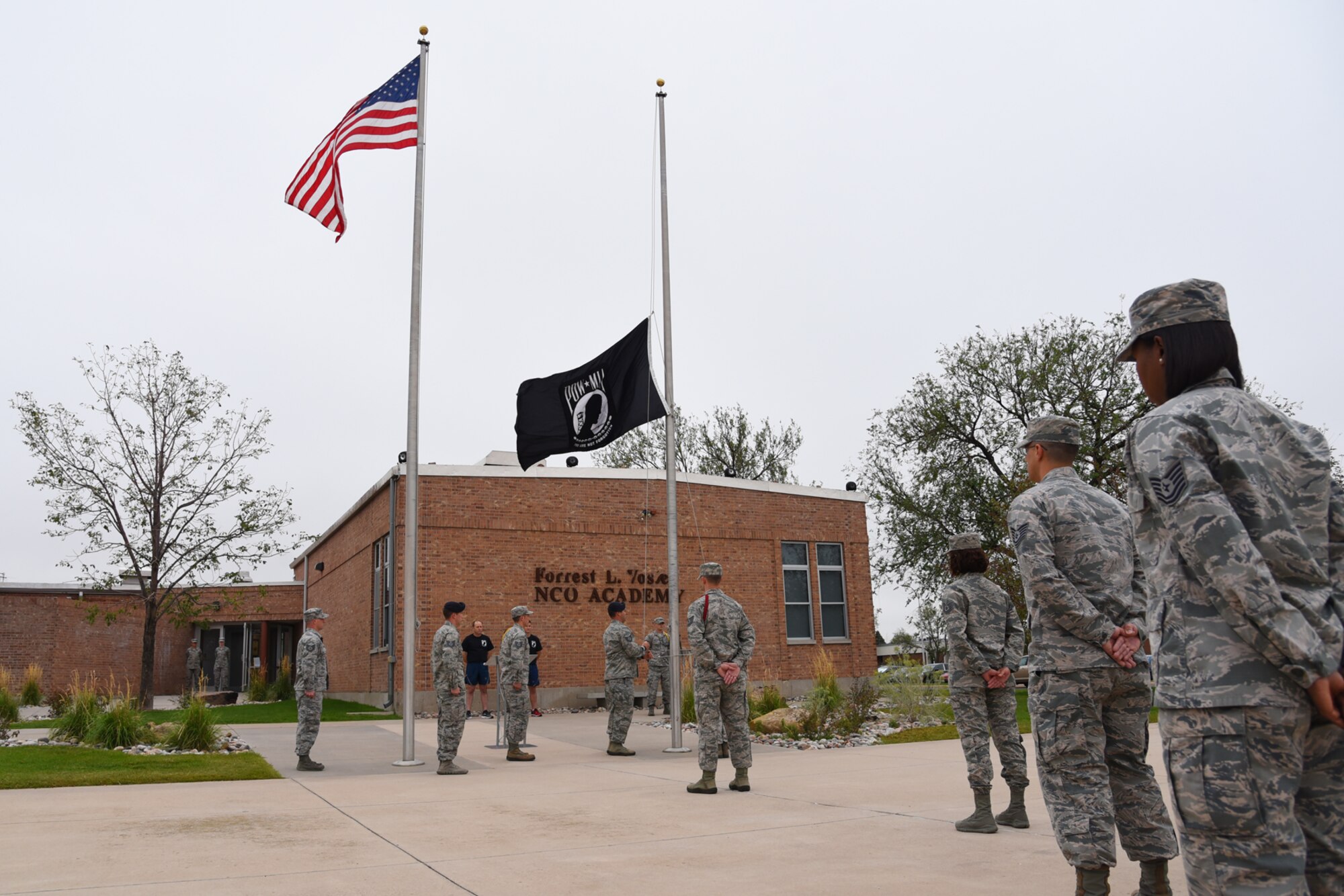 PETERSON AIR FORCE BASE, Colo. – Noncommissioned officers attending the Vosler NCO Academy lower the POW/MIA flag during a retreat ceremony at Peterson Air Force Base, Colo., Sept. 13, 2016. After the ceremony, Team Pete members ran with the flag for 24 consecutive hours to honor lives lost and those who went missing in battle. (U.S. Air Force photo by Airman 1st Class Dennis Hoffman)