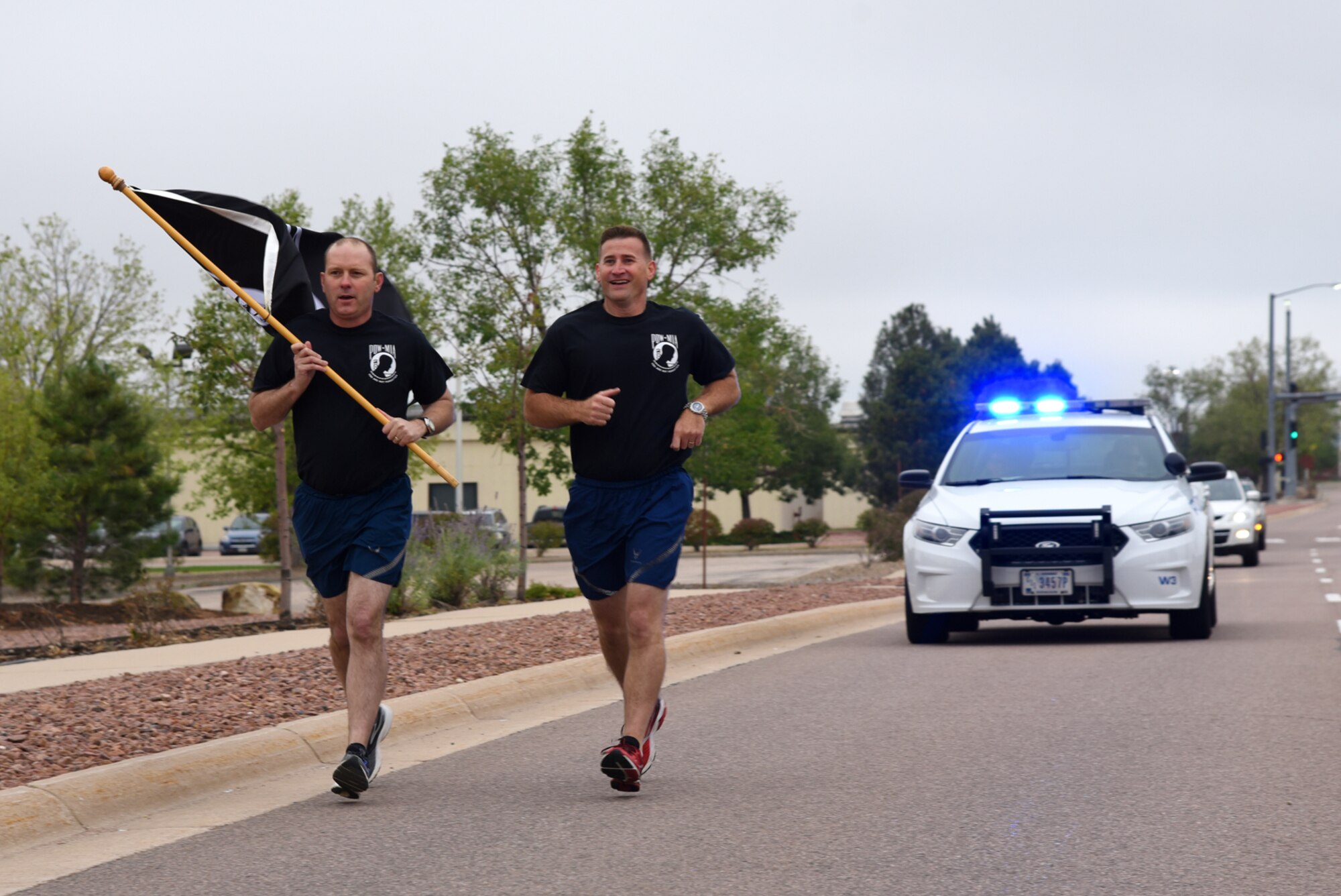 PETERSON AIR FORCE BASE, Colo. – Col. Doug Schiess, 21st Space Wing commander, and Chief Master Sgt. Mark Bronson, 21st Space Wing command chief, kick off the 24-hour POW/MIA run at Peterson Air Force Base, Colo., Sept. 13, 2016. Individuals, flights and squadrons all participated in the 24-hour POW/MIA run to honor lives lost and those missing in action. (U.S. Air Force photo by Airman 1st Class Dennis Hoffman)