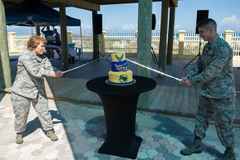 Col. Julie Stola, 45th Medical Group commander, and Airman Keegan Atherton, 45th Medical Support Squadron medical logistics, cut a birthday cake during the Air Force’s 69th Birthday celebration at the Beach House Sept. 16, 2016, at Patrick Air Force Base, Fla. The Air Force is a celebration of the proud history and heritage of American Airmen, the service’s longstanding culture of innovation, and the unique global aspects of Airpower and the Air Force’s enduring contribution to national security. (U.S. Air Force photo/Benjamin Thacker) 