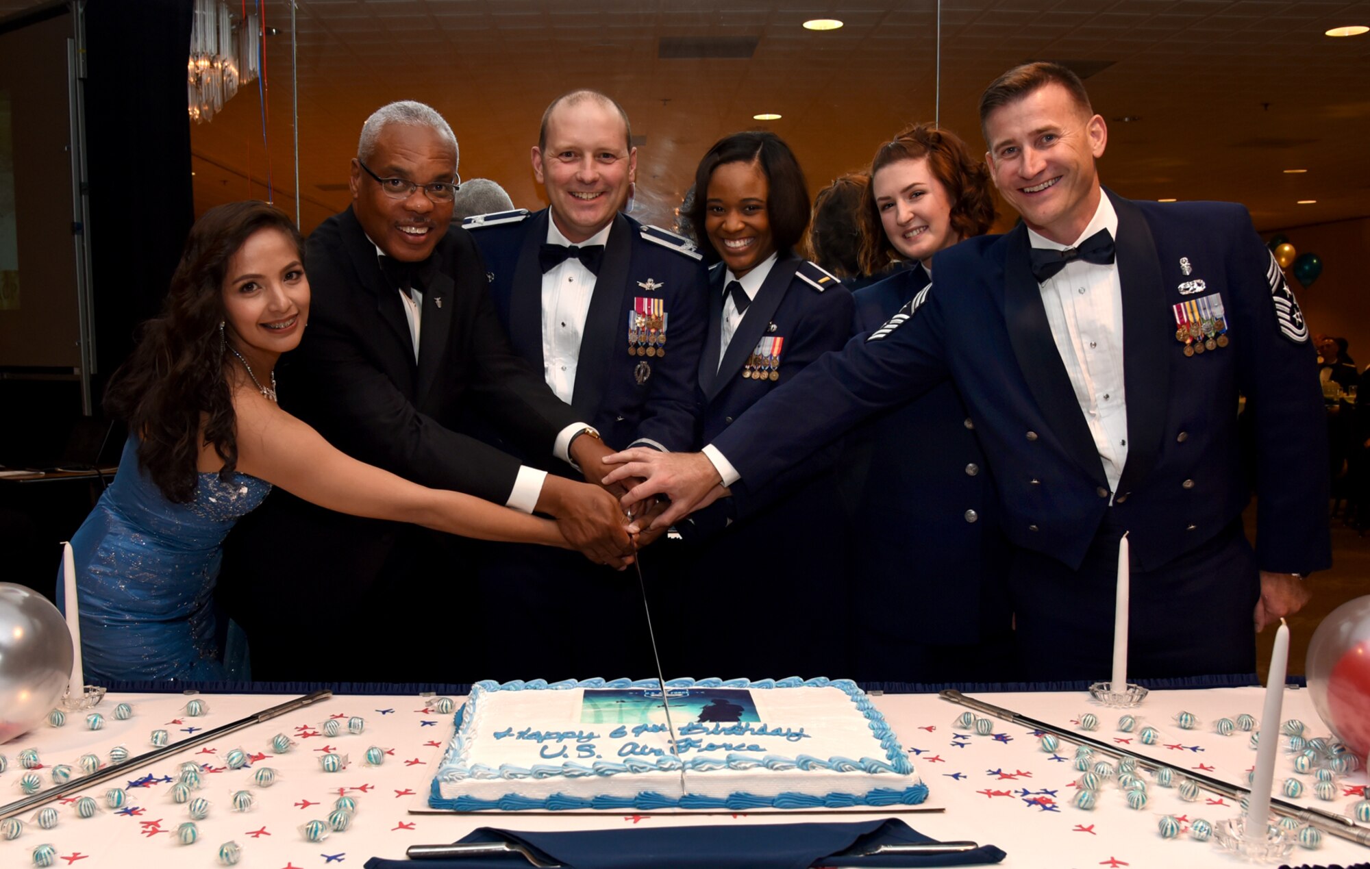 PETERSON AIR FORCE BASE, Colo. – 21st Space Wing leadership kept with tradition by having the lowest ranking dinner attendees help cut the birthday cake during the Air Force Ball at Peterson Air Force Base, Colo., Sept. 18, 2016. All members of Team Pete were encouraged to come out and celebrate the Air Force’s birthday with dinner and dancing. (U.S. Air Force photo by Airman 1st Class Dennis Hoffman)