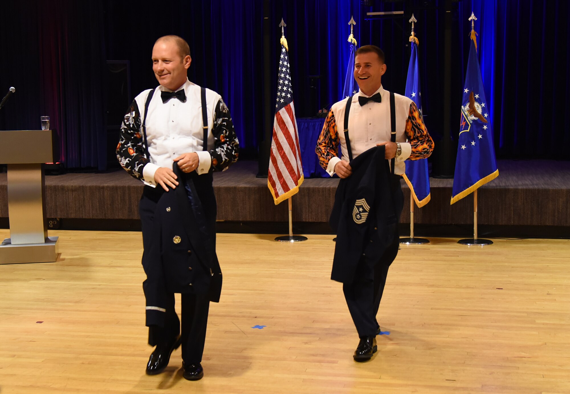 PETERSON AIR FORCE BASE, Colo. – Col. Doug Schiess, 21st Space Wing commander, and Chief Master Sgt. Mark Bronson, 21st Space Wing command chief, unveil their party attire during the Peterson Air Force Base Birthday Ball in The Club at Peterson Air Force Base, Colo., Sept. 18, 2016. All members of Team Pete were encouraged to come out and celebrate the Air Force’s 69th birthday with dinner and dancing. (U.S. Air Force photo by Airman 1st Class Dennis Hoffman)